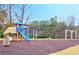 Fun community playground with swings and slide amid a wooded backdrop at 2314 Shetley Creek Dr, Norcross, GA 30071