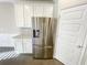 Stainless steel refrigerator and white cabinetry in the kitchen at 2314 Shetley Creek Dr, Norcross, GA 30071