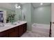 Bright bathroom featuring a double sink vanity and a soaking tub with decorative accents at 2968 Oshields Sw Ct # 4, Marietta, GA 30060