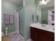 Bathroom showcasing a single sink vanity, framed mirror, glass enclosed shower, and gray paint at 2968 Oshields Sw Ct # 4, Marietta, GA 30060