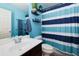 Bathroom featuring blue walls, a striped shower curtain, and decorative shelves above the toilet at 2968 Oshields Sw Ct # 4, Marietta, GA 30060