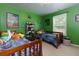 bedroom with bright green walls, two twin beds, and playful decor, perfect for siblings or guests at 2968 Oshields Sw Ct # 4, Marietta, GA 30060