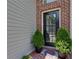 Charming entryway featuring a brick facade, decorative door, and potted plants creating a welcoming entrance at 2968 Oshields Sw Ct # 4, Marietta, GA 30060