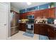 Modern kitchen with stainless steel appliances and elegant cherry wood cabinets, ready for any chef at 2968 Oshields Sw Ct # 4, Marietta, GA 30060