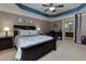 Comfortable main bedroom featuring a tray ceiling, ceiling fan, and ensuite bathroom access at 2968 Oshields Sw Ct # 4, Marietta, GA 30060