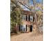 Charming two-story brick home featuring black shutters, large windows, and a front yard covered in colorful fall leaves at 687 Redland Dr # 687, Riverdale, GA 30238