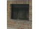 Close-up of a traditional brick fireplace with a black firebox at 687 Redland Dr # 687, Riverdale, GA 30238