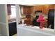 View of the kitchen featuring brown cabinets, a black refrigerator and updated appliances at 687 Redland Dr # 687, Riverdale, GA 30238