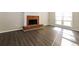 Living room with dark wood floors, a brick fireplace, and bright windows at 687 Redland Dr # 687, Riverdale, GA 30238