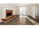 Living room with dark wood floors, fireplace, and windows providing natural light at 687 Redland Dr # 687, Riverdale, GA 30238