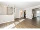Open-concept living area with wood floors leading to kitchen and stairway at 687 Redland Dr # 687, Riverdale, GA 30238