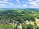 An aerial view features the property with inset photo highlighting its charming curb appeal and landscaped yard at 1467 Hewatt Rd, Lilburn, GA 30047