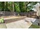 Private backyard with wooden fence, natural foliage, and a concrete patio space perfect for entertaining at 1467 Hewatt Rd, Lilburn, GA 30047