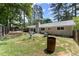Expansive backyard with mature trees, lush lawn, and space for recreation and relaxation at 1467 Hewatt Rd, Lilburn, GA 30047