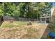 Large, private backyard with mature trees and space for outdoor entertaining and activities at 1467 Hewatt Rd, Lilburn, GA 30047