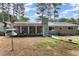 Lush backyard with a well-maintained lawn, mature trees, and a screened porch for outdoor enjoyment at 1467 Hewatt Rd, Lilburn, GA 30047