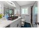 Modern bathroom with a sleek vanity, dark vessel sink, updated fixtures, and glass-enclosed shower at 1467 Hewatt Rd, Lilburn, GA 30047
