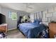Comfortable bedroom featuring a ceiling fan, ample natural light, and hardwood floors at 1467 Hewatt Rd, Lilburn, GA 30047