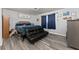 Cozy bedroom featuring a futon, hardwood floors, and plenty of natural light at 1467 Hewatt Rd, Lilburn, GA 30047