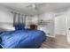 Comfortable bedroom features a ceiling fan, hardwood floors, and stylish built-in shelving at 1467 Hewatt Rd, Lilburn, GA 30047