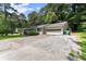 A one-story home with an attached garage and a wide driveway at 1467 Hewatt Rd, Lilburn, GA 30047