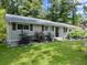Lovely single-story home featuring gray siding, shutters, and lush front yard at 1467 Hewatt Rd, Lilburn, GA 30047