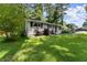 Well-maintained single-story home with a beautiful green lawn and landscape at 1467 Hewatt Rd, Lilburn, GA 30047