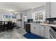 Renovated kitchen featuring grey cabinetry, modern appliances, and a combined dining area at 1467 Hewatt Rd, Lilburn, GA 30047