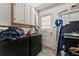 Functional laundry room with modern washer and dryer, storage cabinets, and access to the exterior at 1467 Hewatt Rd, Lilburn, GA 30047