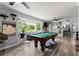 Spacious recreation room featuring a bay window, pool table, and comfortable seating area at 1467 Hewatt Rd, Lilburn, GA 30047