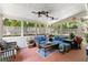 Cozy screened porch with comfortable seating, ceiling fans, and a view of the landscaped backyard at 1467 Hewatt Rd, Lilburn, GA 30047