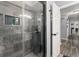 Stylish walk-in shower featuring stone floors, tiled walls, and modern fixtures at 1467 Hewatt Rd, Lilburn, GA 30047