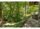 Serene backyard setting with stone steps leading down to a natural, wooded area at 2016 Castleway Ne Dr, Atlanta, GA 30345