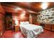 This cozy bedroom features beautiful wood paneling, stone accents, and built in shelving at 2016 Castleway Ne Dr, Atlanta, GA 30345