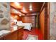 A mid-century modern bedroom showcasing wood paneled walls, stone accents, and built in storage at 2016 Castleway Ne Dr, Atlanta, GA 30345