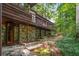 A view of the home's exterior showing wood and stone elements, as well as the surrounding yard at 2016 Castleway Ne Dr, Atlanta, GA 30345
