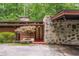 Stone and wood exterior showcasing a unique architectural design with a Japanese maple in front at 2016 Castleway Ne Dr, Atlanta, GA 30345
