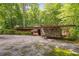 Unique stone and wood home with flat roof design and expansive front yard at 2016 Castleway Ne Dr, Atlanta, GA 30345