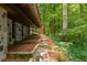 An exterior view showcases the stone walls, terraced landscaping, and wooded privacy at 2016 Castleway Ne Dr, Atlanta, GA 30345