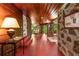 Spacious hallway with stone walls, wood ceilings, concrete floors, and access to outdoor porch area at 2016 Castleway Ne Dr, Atlanta, GA 30345