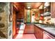 Kitchen featuring stainless steel appliances, wooden cabinetry, and stone walls at 2016 Castleway Ne Dr, Atlanta, GA 30345