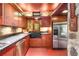 Kitchen featuring stainless steel appliances, wooden cabinetry, and stone walls at 2016 Castleway Ne Dr, Atlanta, GA 30345
