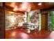 Bright and airy living room with stone walls, wood ceilings, concrete floors, and comfortable seating at 2016 Castleway Ne Dr, Atlanta, GA 30345