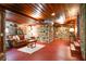 Open living room with stone walls, exposed wood beam ceiling and a comfortable seating area with stairs at 2016 Castleway Ne Dr, Atlanta, GA 30345