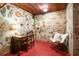 Small office space with stone walls, wood ceilings, concrete floors, desk, chair, and good lighting at 2016 Castleway Ne Dr, Atlanta, GA 30345