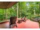 Covered patio featuring wooded views, outdoor seating with chairs and a small wood table at 2016 Castleway Ne Dr, Atlanta, GA 30345