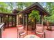 Inviting outdoor patio featuring stone accents, comfortable seating, and lush green surroundings at 2016 Castleway Ne Dr, Atlanta, GA 30345