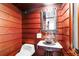 Unique powder room with wood paneling and vintage-style sink at 2016 Castleway Ne Dr, Atlanta, GA 30345