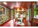 Sitting area with exposed stone accent walls, wood ceiling, and floor-to-ceiling window at 2016 Castleway Ne Dr, Atlanta, GA 30345