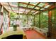 Sunroom with a wooden frame, transparent roof, and a view of the surrounding greenery at 2016 Castleway Ne Dr, Atlanta, GA 30345